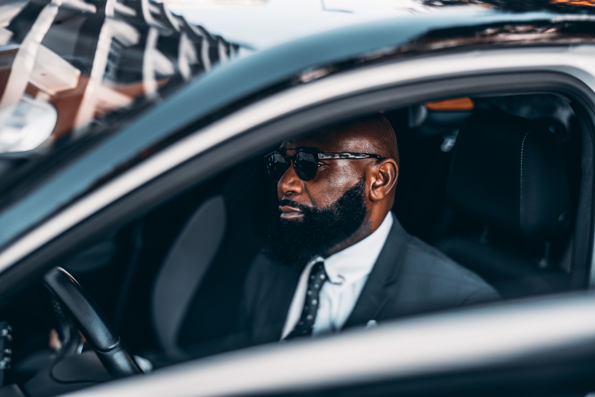 African businessman in a black car