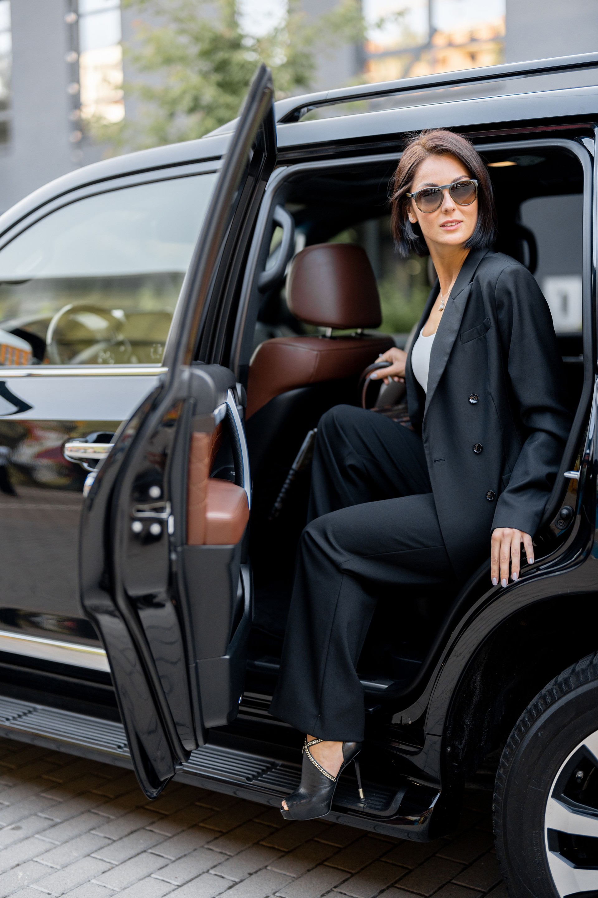 Portrait of an elegant business lady in SUV taxi